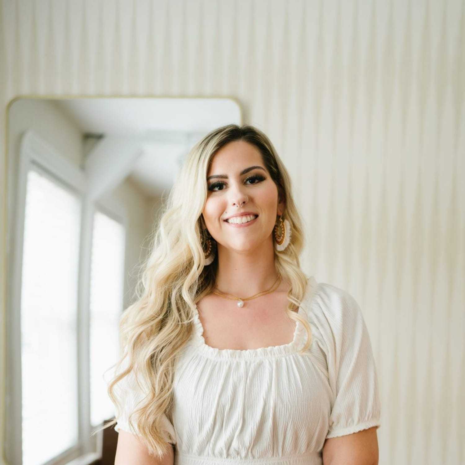 Portrait of Caitlin, a professional stylist at 1604 Salon, showcasing their expertise and style.